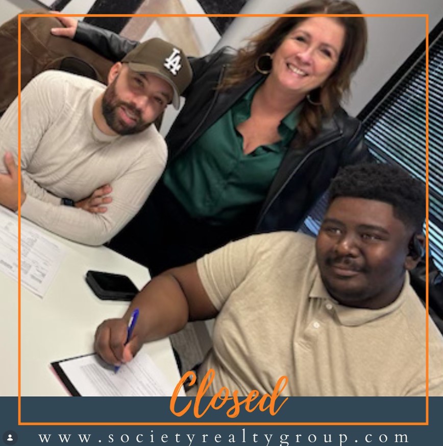 A client signing closing documents with Brandon Lucas